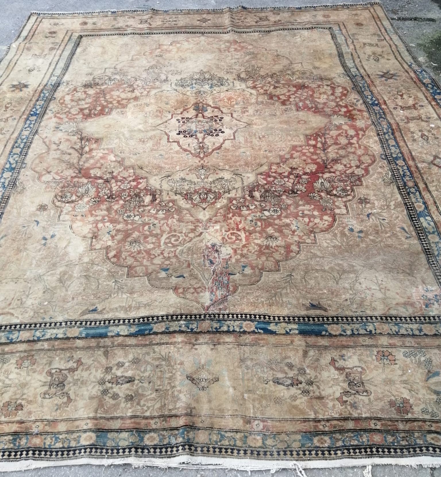 A fine Persian cream ground carpet, in distressed condition, 360 x 300cm